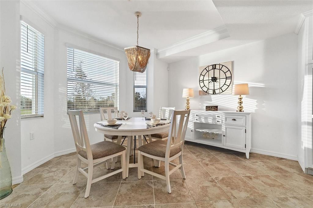 Dining area featuring ornamental molding and a chandelier