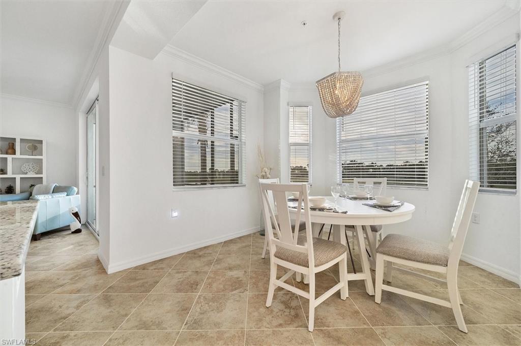 Dining area featuring crown molding and light tile patterned floors