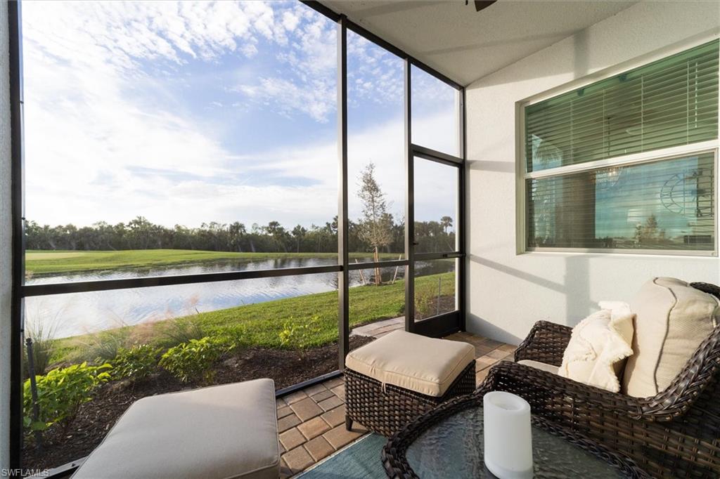 Sunroom featuring a water view and a ceiling fan