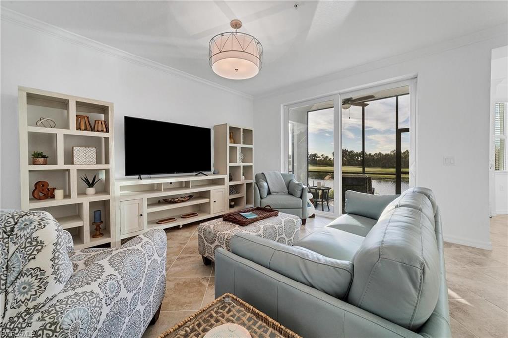 Living room with ornamental molding and light tile patterned floors