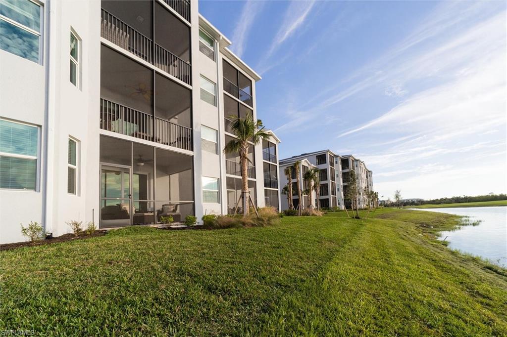 View of apartment building / complex featuring a water view