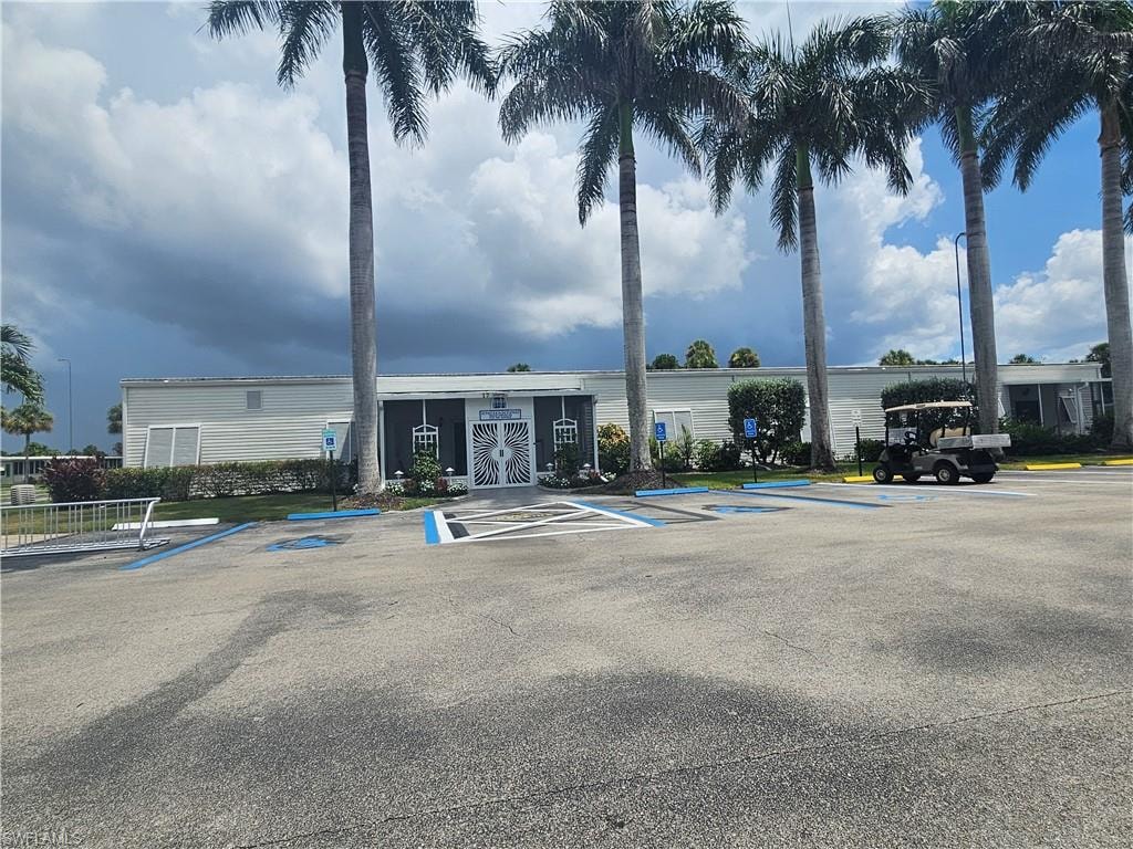 View of property with uncovered parking