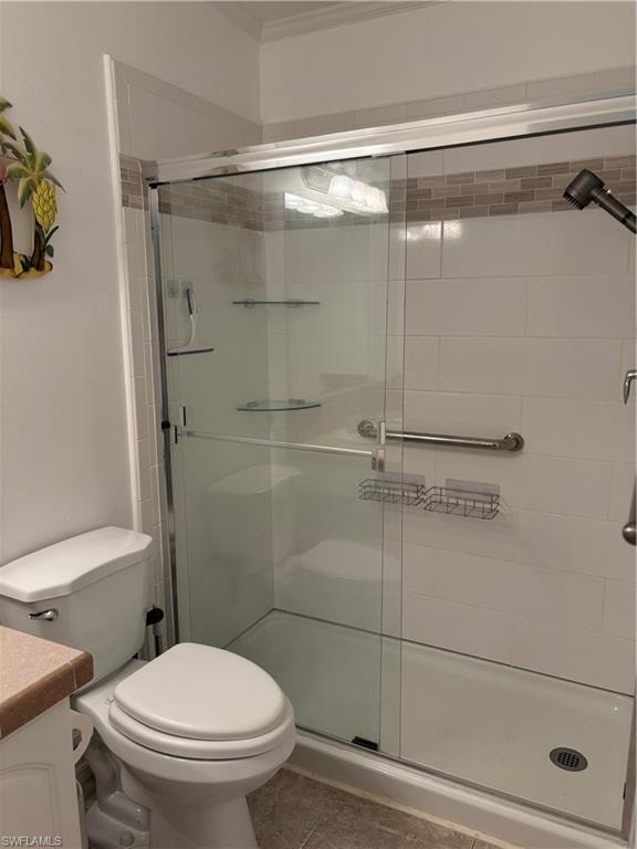 Bathroom featuring vanity, a shower stall, and light tile patterned flooring