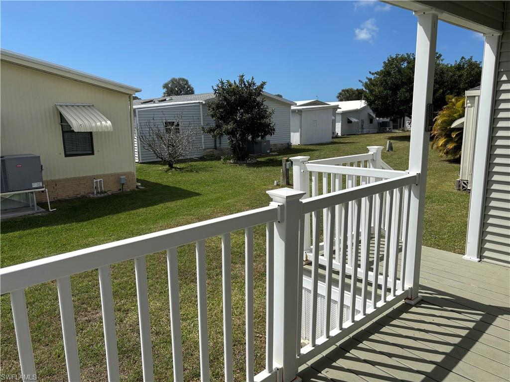 Wooden deck featuring a lawn