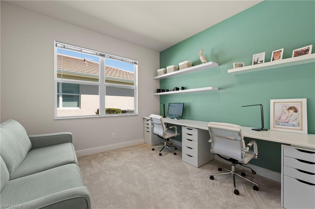 Office featuring light carpet and baseboards
