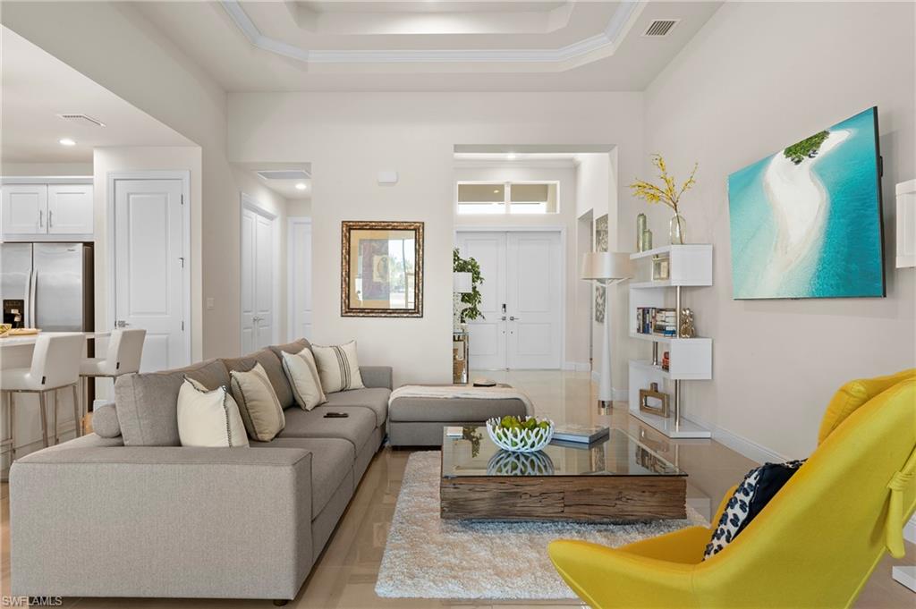 Living room featuring parquet flooring and a high tray ceiling