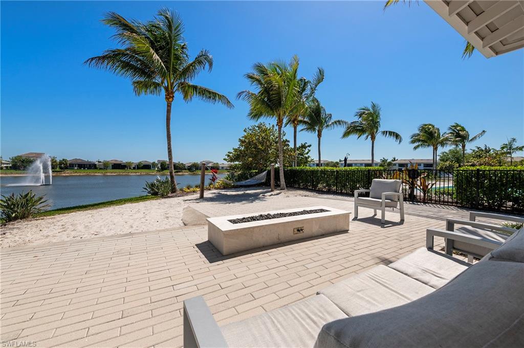View of patio / terrace featuring a water view, an outdoor fire pit, and a residential view