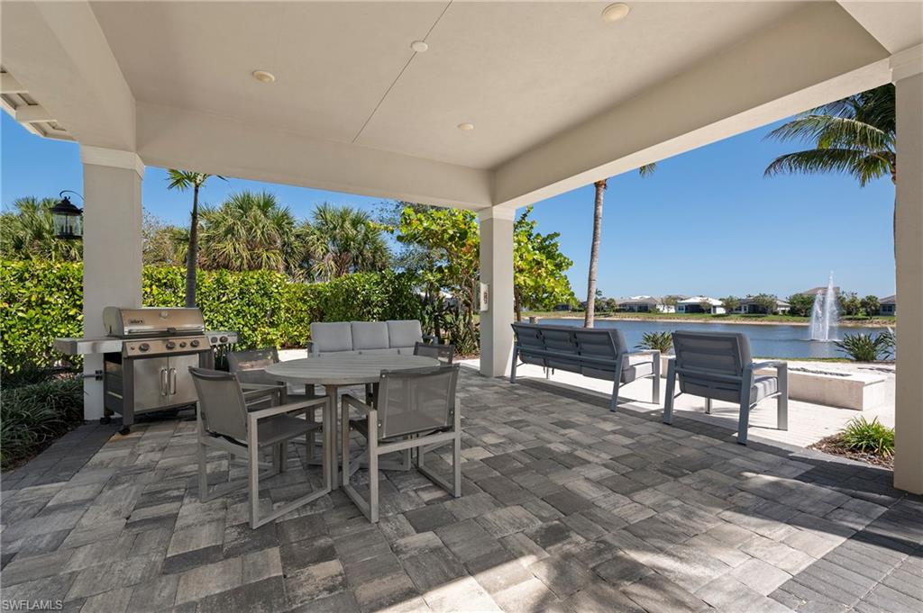View of patio with a water view and outdoor dining area