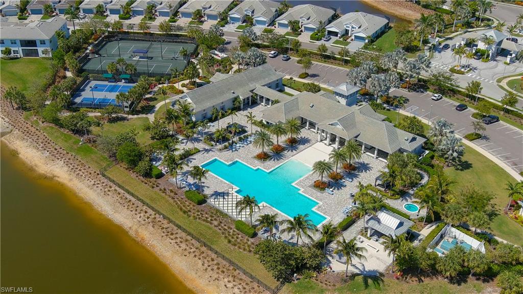 Bird's eye view of a nearby body of water and a pool