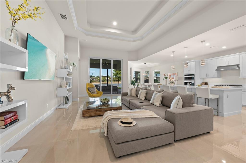 Living room with recessed lighting and a raised ceiling