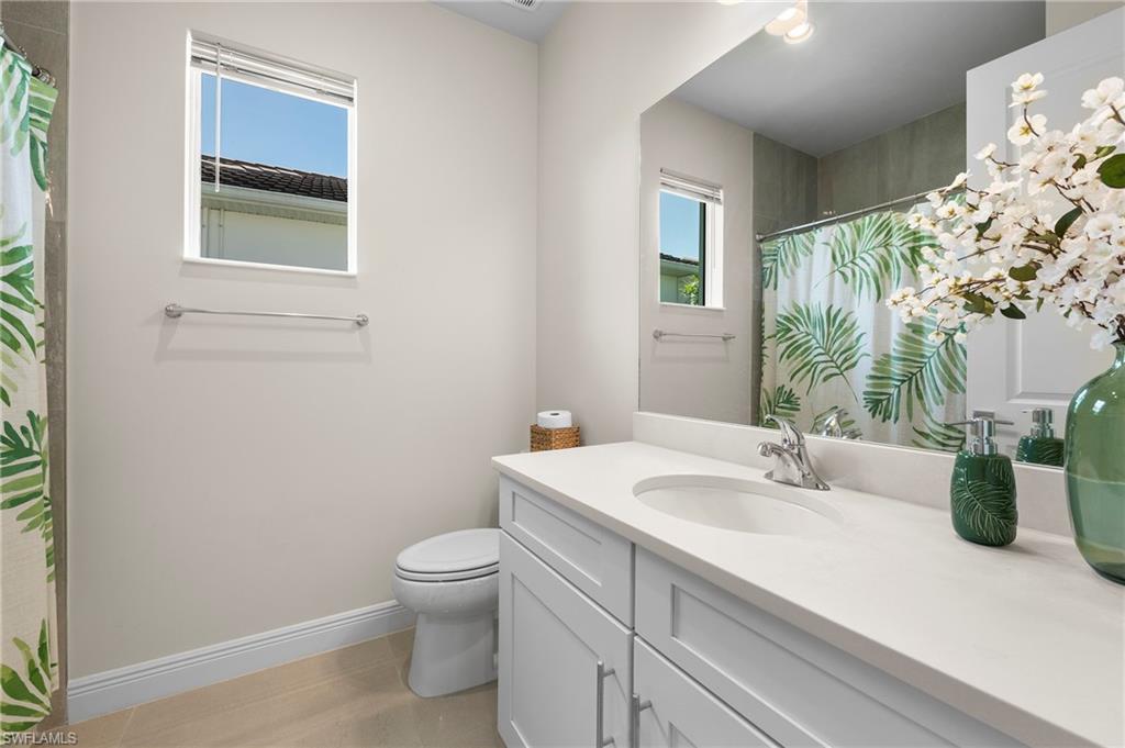 Full bath with vanity and curtained shower