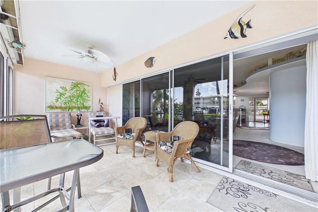 Sunroom with a ceiling fan, a patio area, and an outdoor lounge area
