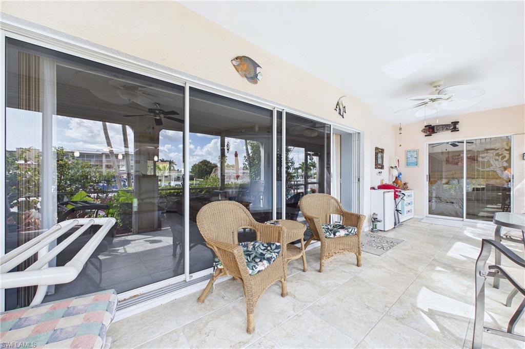 Pocket sliders to Sunroom with a ceiling fan and a patio.  Sliders into Primary Bedroom