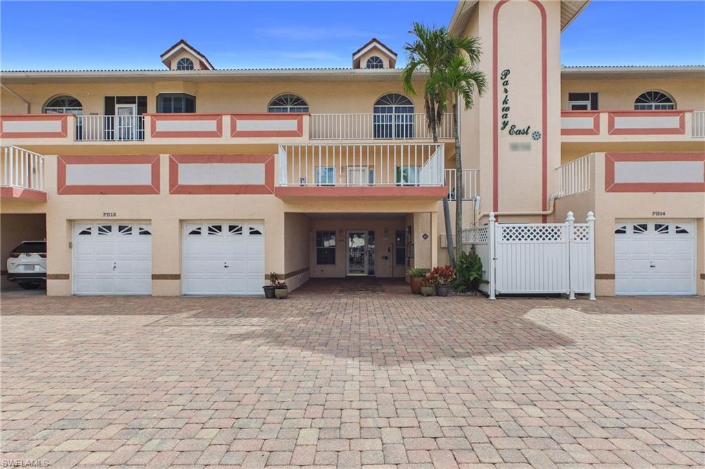 View of front of property with stucco siding and a garage