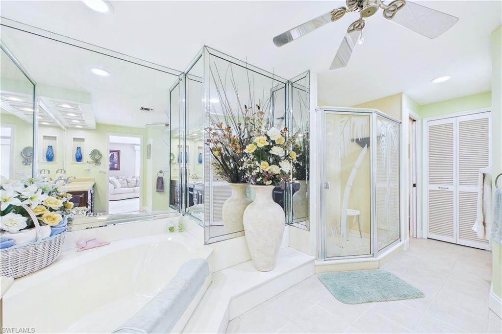 Ensuite bathroom with a garden tub, a ceiling fan, a stall shower, recessed lighting, and a closet