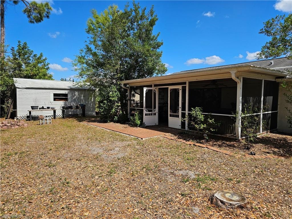 Back of house featuring a sunroom