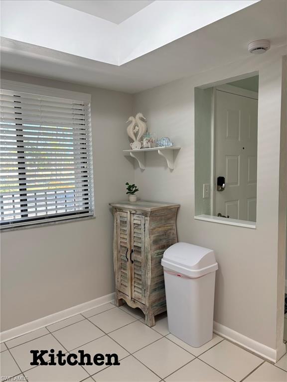 Kitchen nook, baseboards and light tile patterned flooring