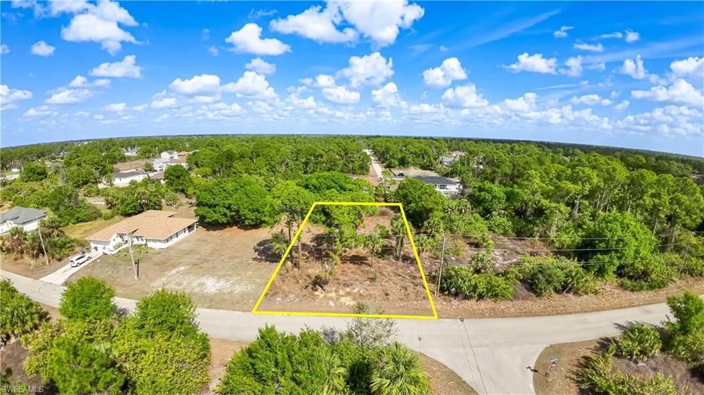 Aerial overview of property's location with property parcel outlined and a forest