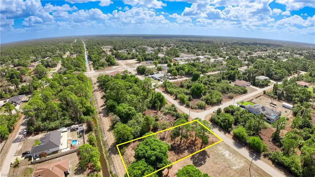 Aerial perspective of suburban area featuring property parcel outlined