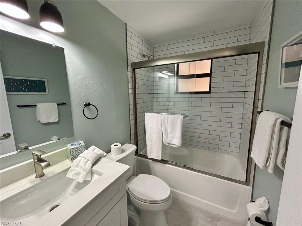 Primary bathroom with vanity and enclosed tub / shower combo