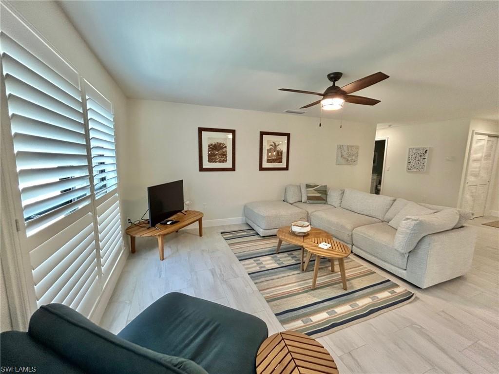 Living room featuring ceiling fan and light finished floors