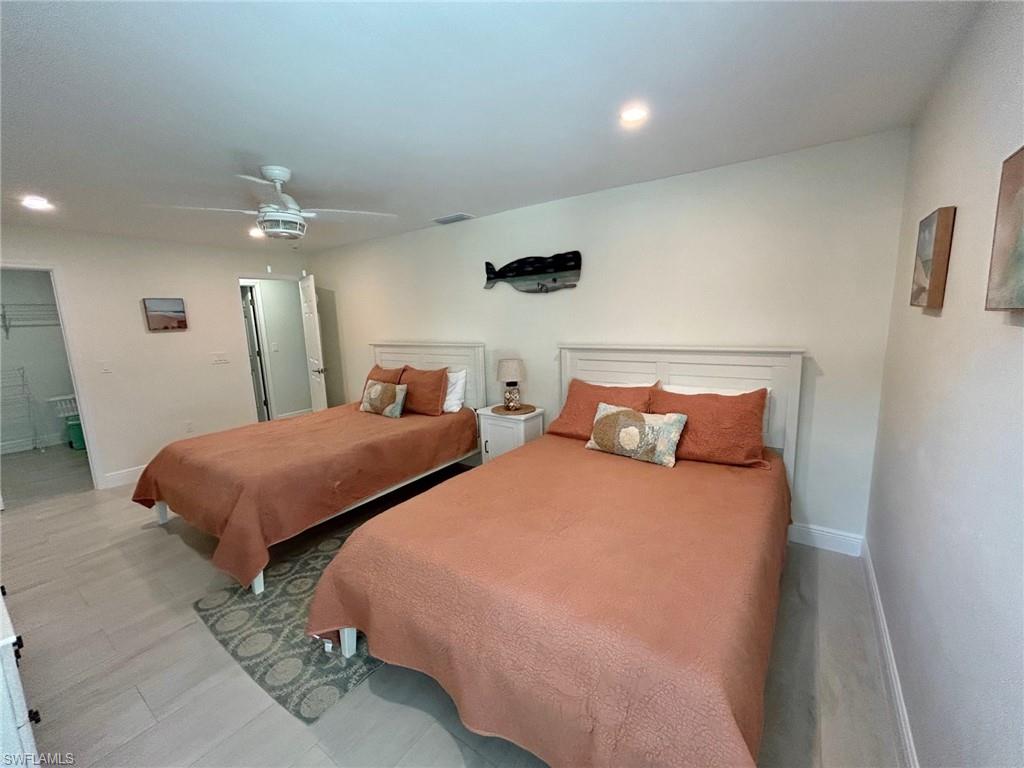 Guest bedroom with ceiling fan and recessed lighting