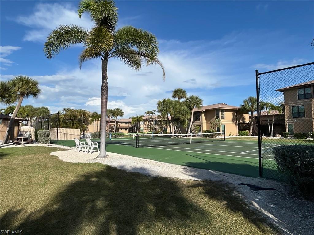 Surrounding community featuring a tennis court