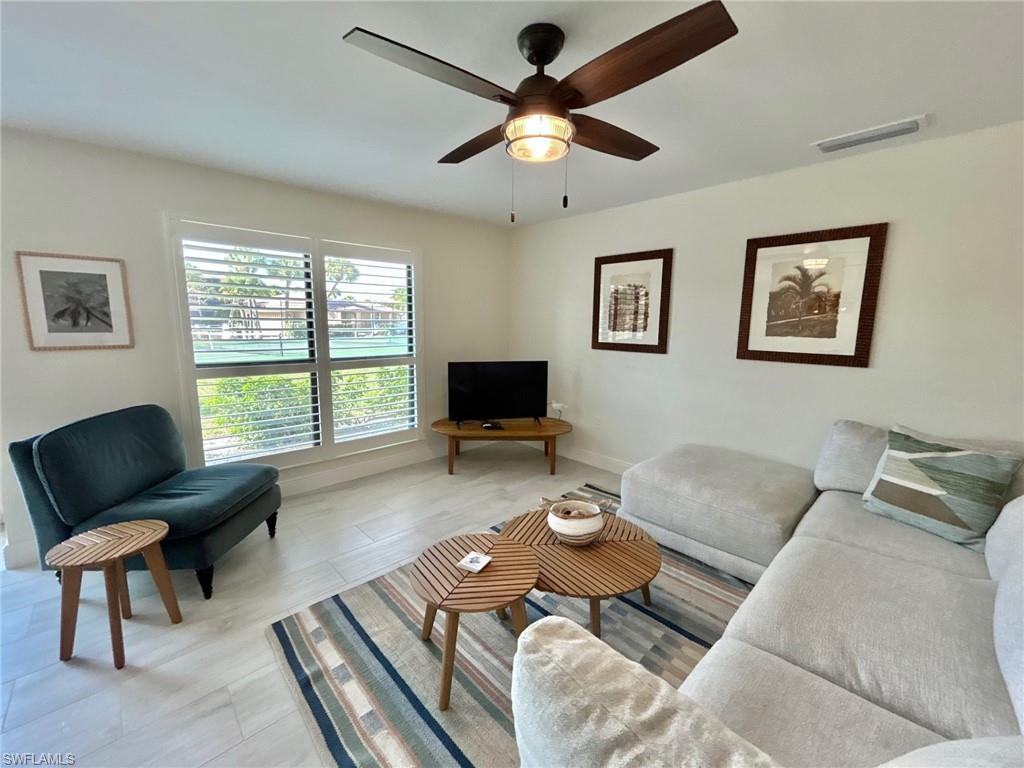 Living room featuring a ceiling fan and baseboards