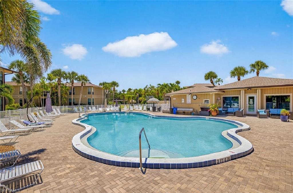 Community pool with a patio area and outdoor seating