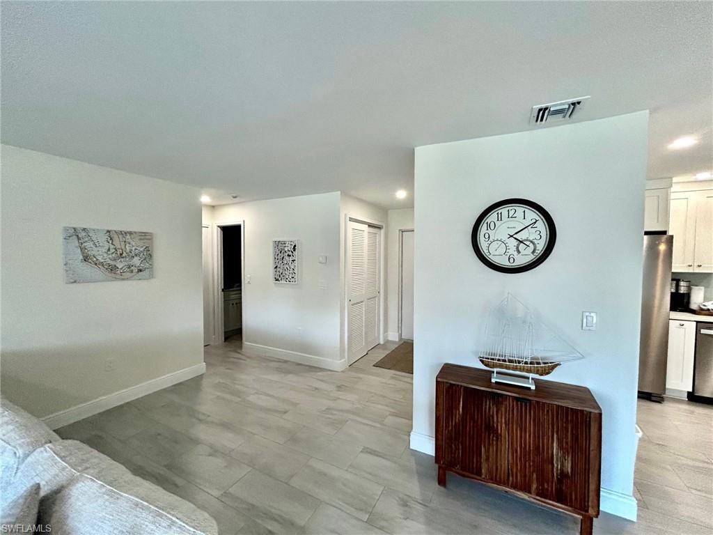 Living area featuring baseboards and recessed lighting