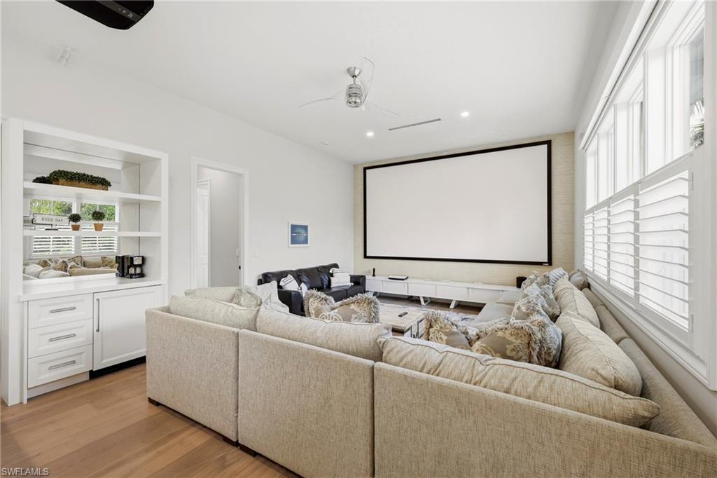 Cinema room with recessed lighting, light wood-type flooring, and a ceiling fan