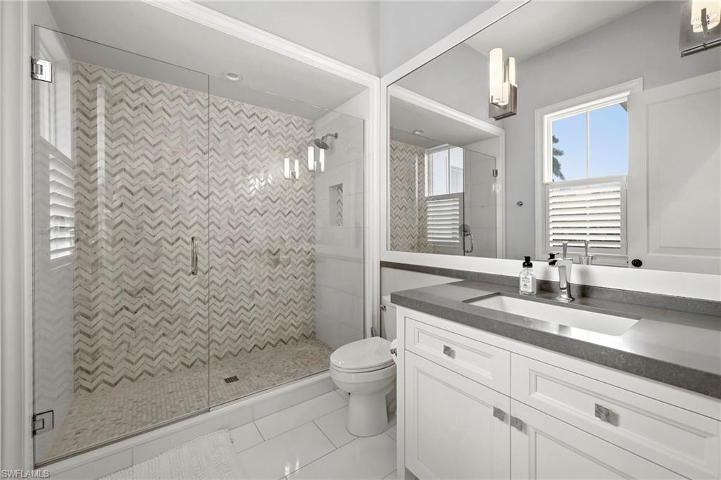 Bathroom with a stall shower, vanity, and light tile patterned floors