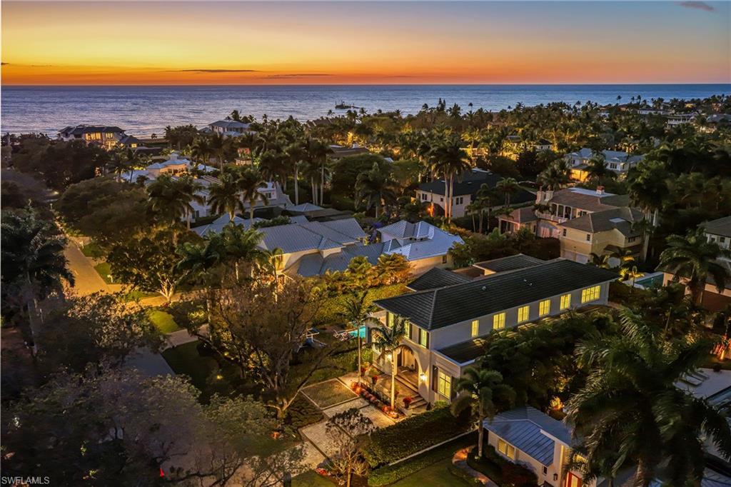Aerial view at dusk of a water view and a residential view