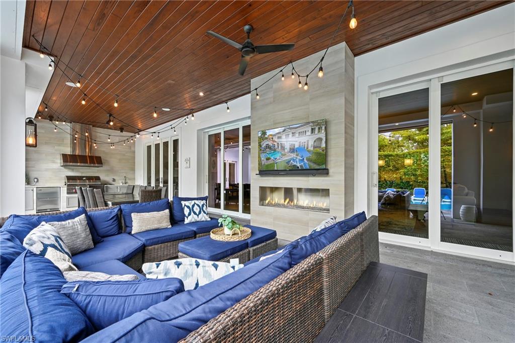 View of patio / terrace featuring an outdoor kitchen and area to lounge and ceiling fan