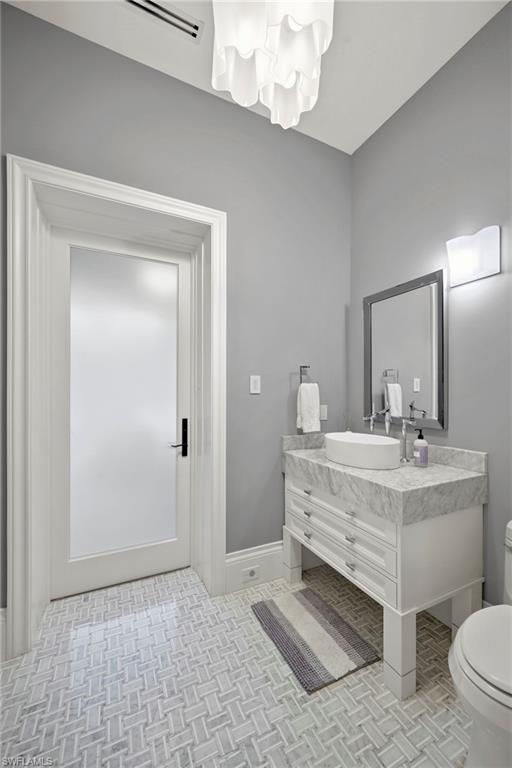 Half bath featuring vanity and toilet