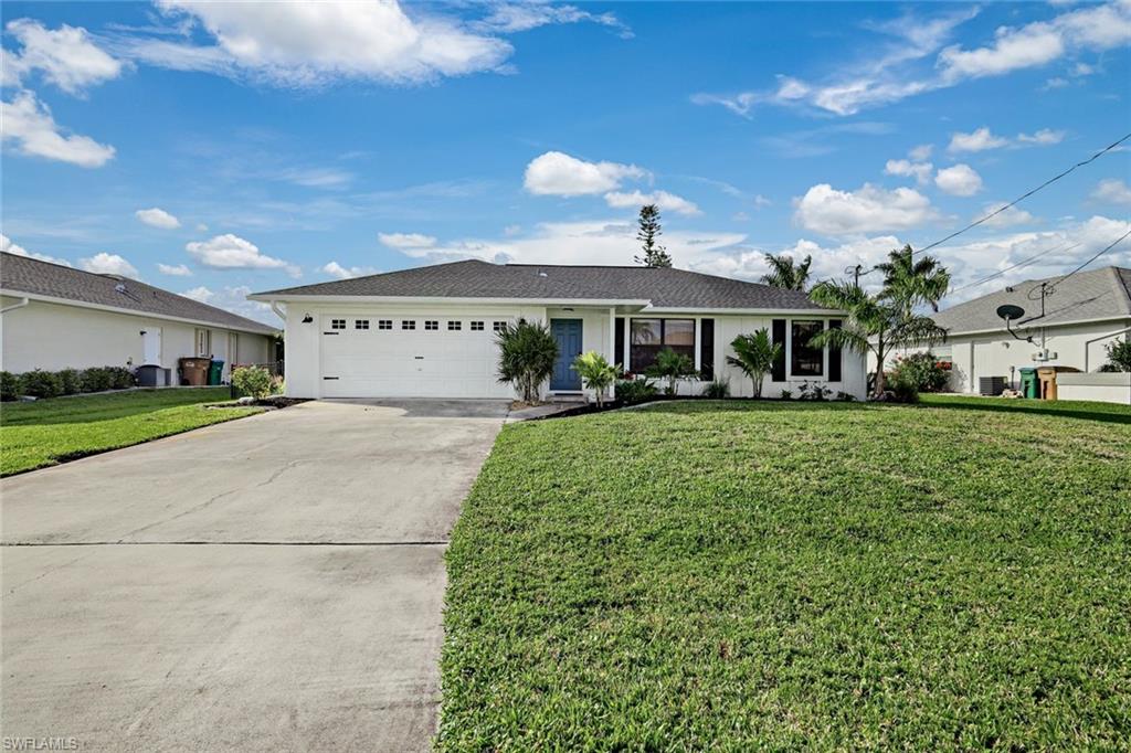 Single story home featuring a front lawn, concrete driveway, a garage, and stucco siding