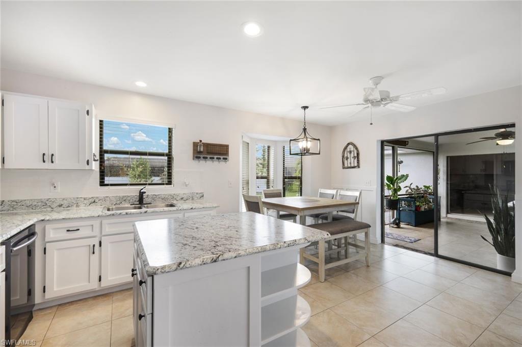 Kitchen featuring white cabinetry, a kitchen island, and plenty of natural light