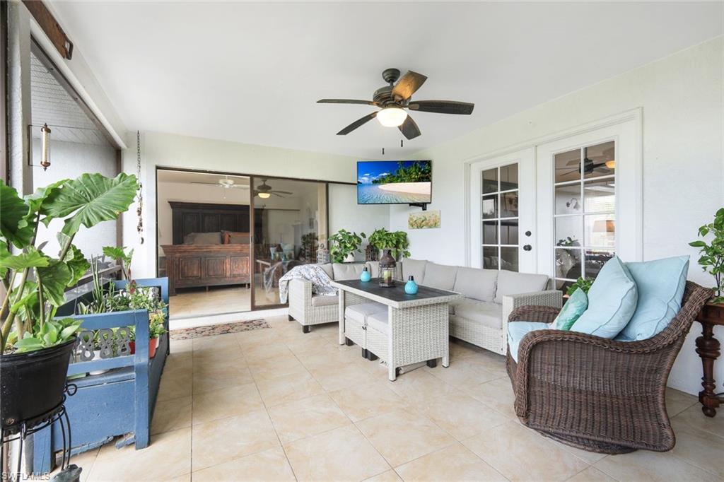 Sunroom / solarium with french doors, an outdoor lounge area, a ceiling fan, and a patio area