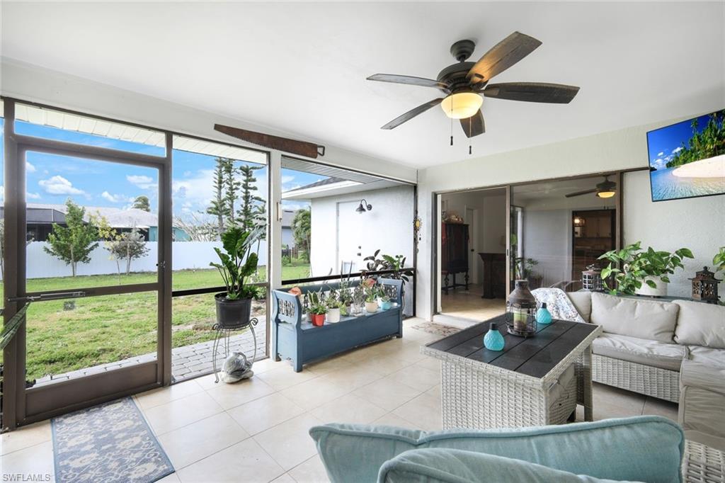 Sunroom / solarium with outdoor seating, ceiling fan, and a water view