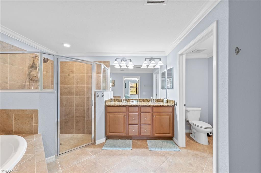Primary bathroom with double sink, walk-in shower and tub