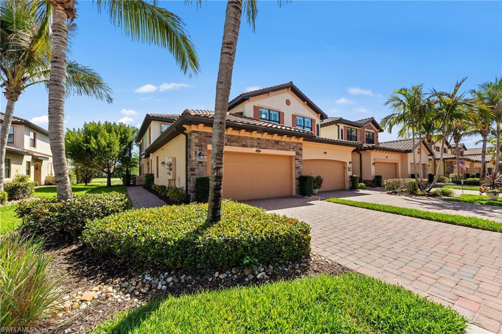 FIRST FLOOR COACH HOME featuring a tile roof, stucco, and a 2 car garage