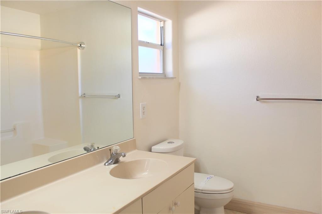 Bathroom featuring double vanity and a shower