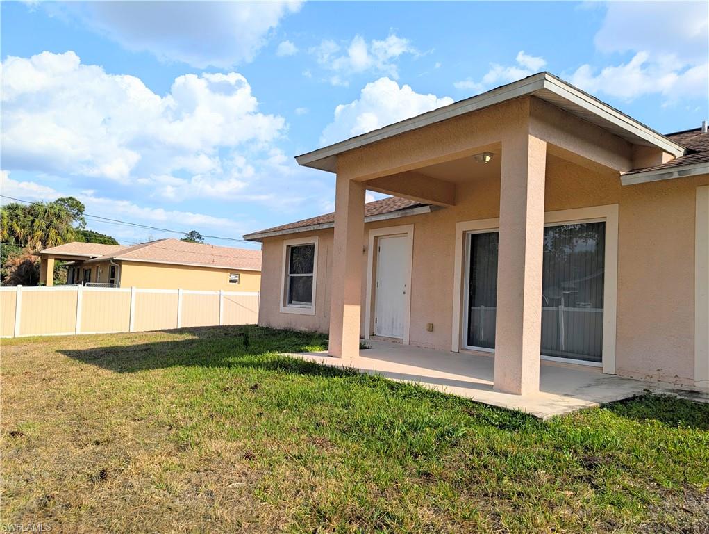Rear view of property with a patio and stucco siding