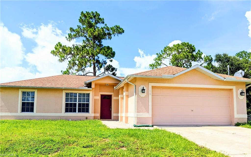 Ranch-style home featuring stucco siding, an attached garage, and concrete driveway