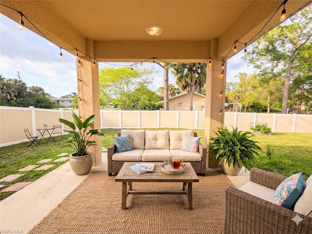 Virtual staged Fenced backyard with outdoor seating and a patio area