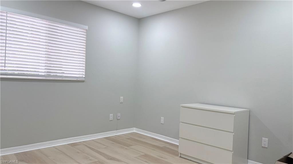 Empty room featuring light wood-type flooring and recessed lighting