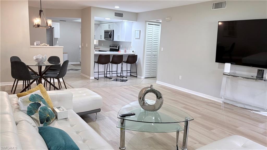 Living room featuring baseboards and light wood-style flooring