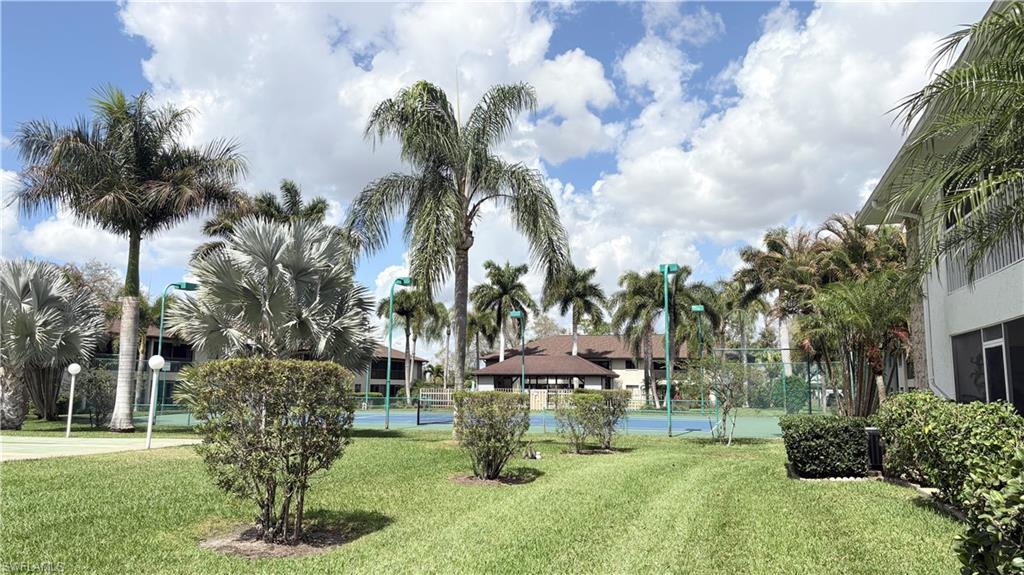 View of home's community featuring a tennis court