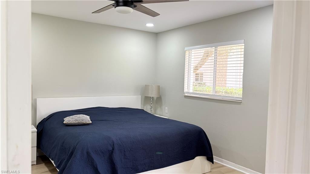 Bedroom featuring a ceiling fan, light wood-style flooring, and recessed lighting