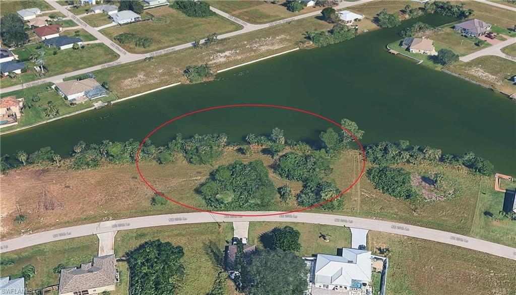 Aerial perspective of suburban area featuring a nearby body of water